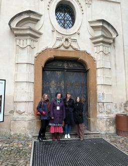 Four women, including Sunni Nishimura and Reba Ouimet from BC ELN, stand in front of a building in Prague